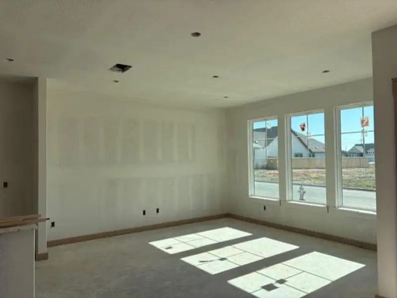 Carpeted empty room with a textured ceiling