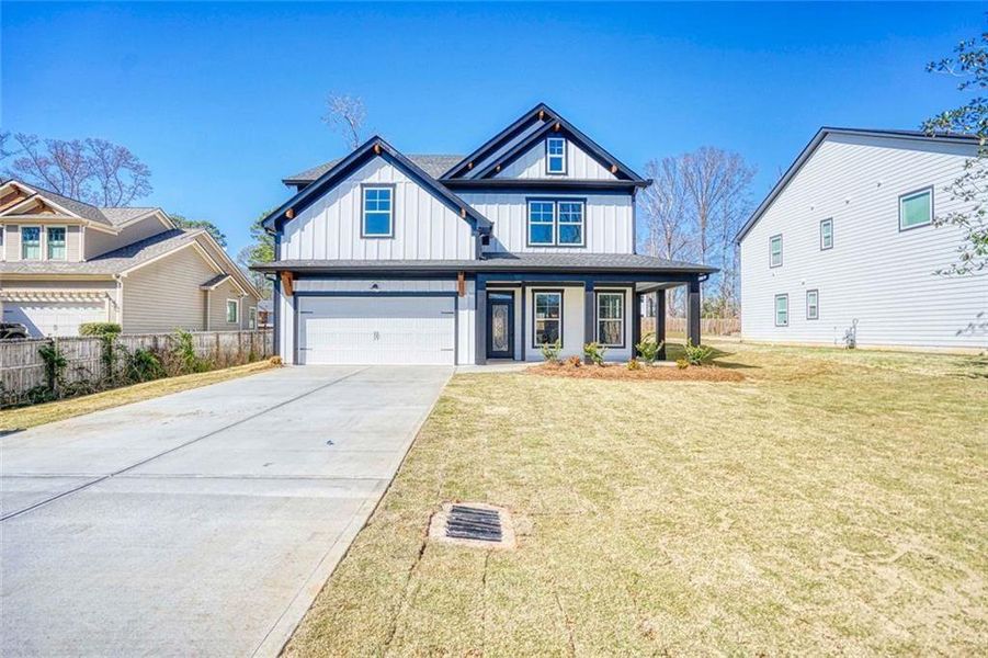 Front exterior of a new home in , Conyers, GA, highlighting curb appeal (Image 1). Front exterior of a new home in , Conyers, GA, highlighting curb appeal (Image 1).