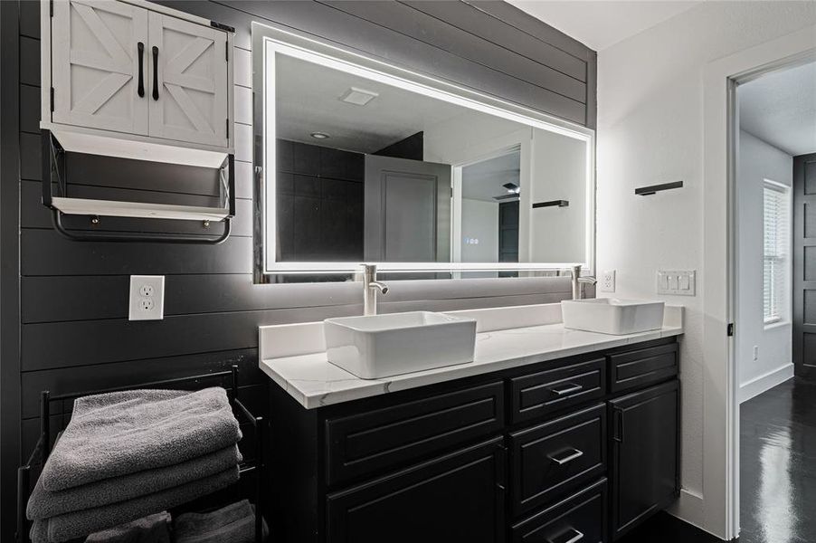 Bathroom with vanity and concrete floors