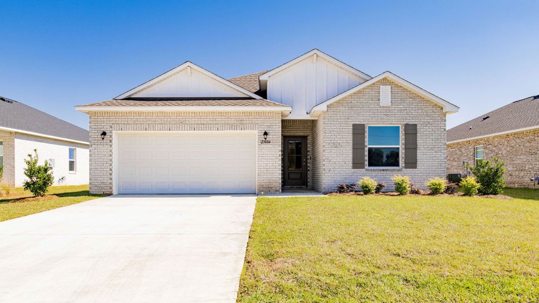 Front exterior of a new home in Oakstone Farms, Leesburg, FL, highlighting curb appeal (Image 27).