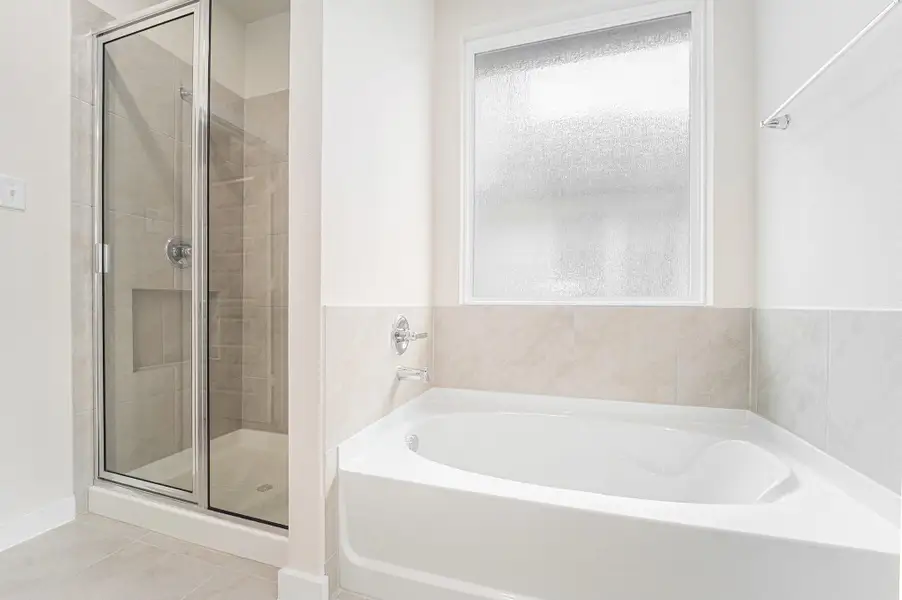 Primary en-suite features double sinks, a separate shower and soaking tub Primary en-suite features double sinks, a separate shower and soaking tub