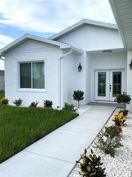 Front exterior of a new home in , Punta Gorda, FL, highlighting curb appeal (Image 1).