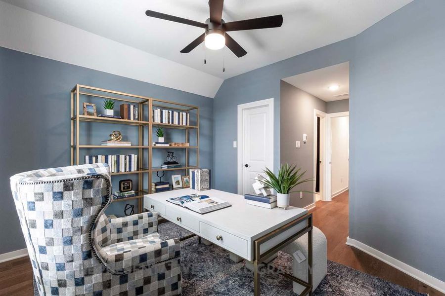 Office area with a ceiling fan and wood finished floors Office area with a ceiling fan and wood finished floors