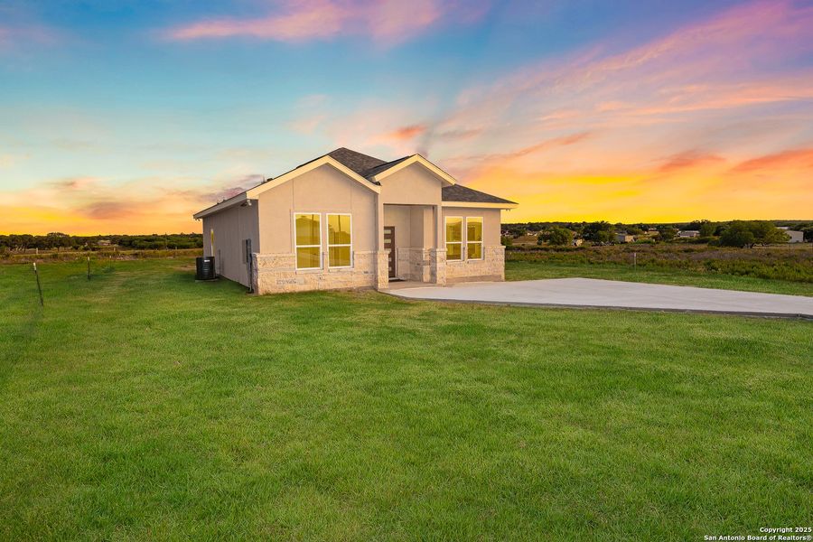 Front exterior of a new home in , La Vernia, TX, highlighting curb appeal (Image 24).