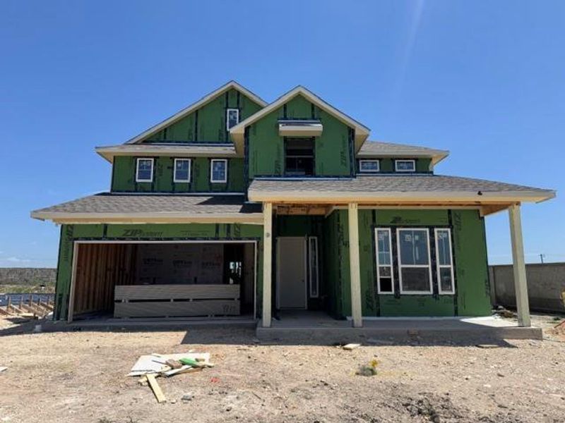 A newly framed residence awaits its final exterior finishes, showcasing a promising architectural design.