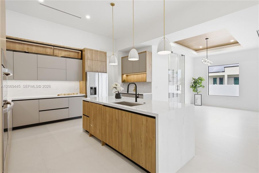 Built-in stainless-steel appliances, induction cooktop and pot filler complete this beautifully appointed chef-inspired kitchen Built-in stainless-steel appliances, induction cooktop and pot filler complete this beautifully appointed chef-inspired kitchen
