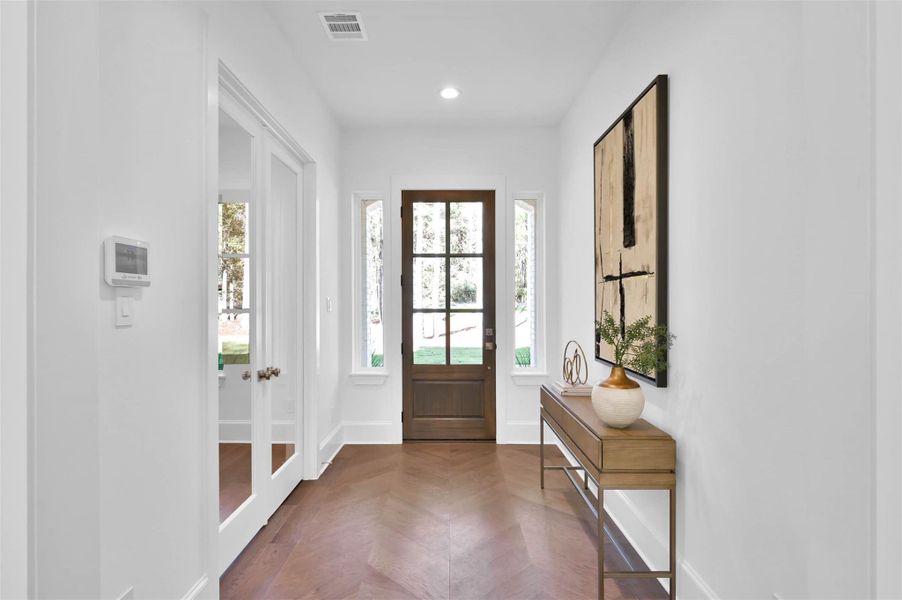 Custom wood floors have upscale herringbone pattern in entry way. Custom 8 ft doors throughout and 12 ft ceilings. Custom wood floors have upscale herringbone pattern in entry way. Custom 8 ft doors throughout and 12 ft ceilings.
