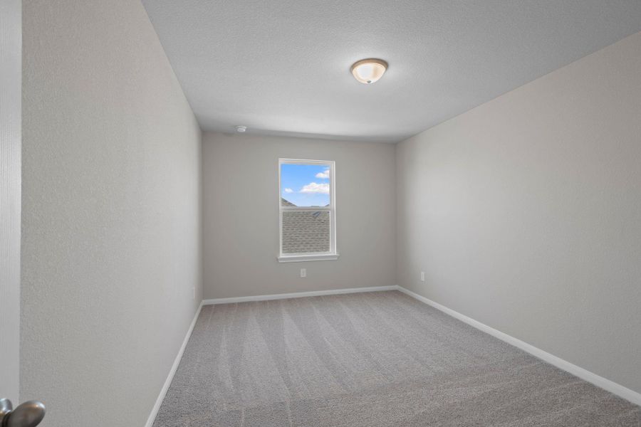 Your secondary bedroom features plush carpet, fresh paint, closet, and a large window that lets in plenty of natural lighting.
