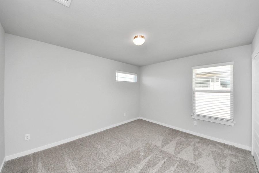 Secondary bedroom features plush carpeting, large windows that let in plenty of natural light, bright paint, and spacious closets. Secondary bedroom features plush carpeting, large windows that let in plenty of natural light, bright paint, and spacious closets.