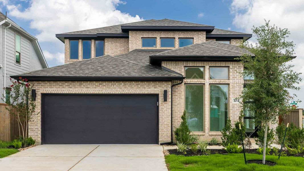 View of front of home featuring roof with shingles, concrete driveway, an attached garage, and brick siding View of front of home featuring roof with shingles, concrete driveway, an attached garage, and brick siding