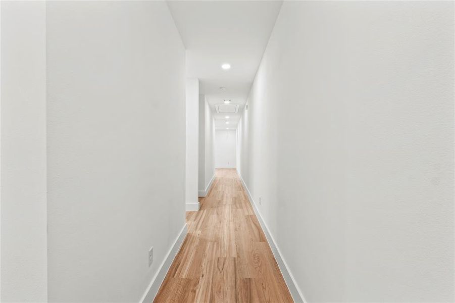 Hall featuring light wood-style flooring and recessed lighting