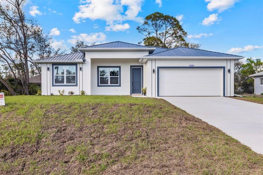 Front exterior of a new home in , North Port, FL, highlighting curb appeal (Image 1). Front exterior of a new home in , North Port, FL, highlighting curb appeal (Image 1).