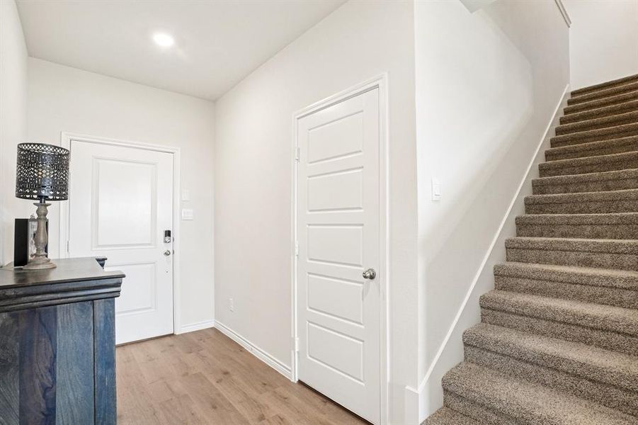 Entryway featuring light wood-type flooring, stairway, and recessed lighting Entryway featuring light wood-type flooring, stairway, and recessed lighting
