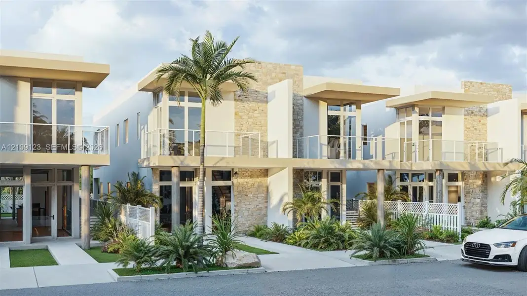 Contemporary multi-unit exterior featuring stacked stone accents, second-story glass-railed balconies, floor-to-ceiling windows, and concrete walkways Contemporary multi-unit exterior featuring stacked stone accents, second-story glass-railed balconies, floor-to-ceiling windows, and concrete walkways