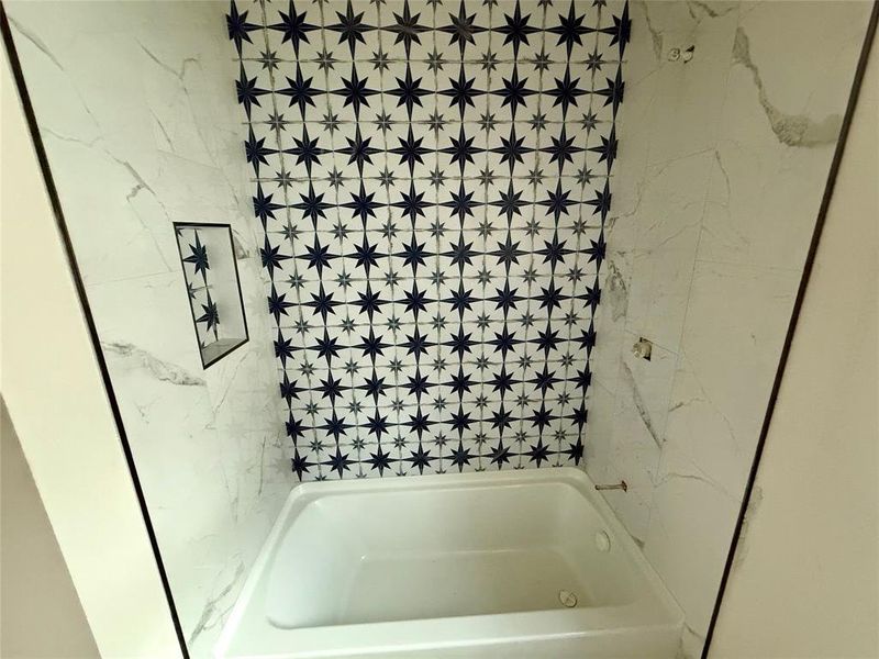 Bathroom featuring tiled shower / bath