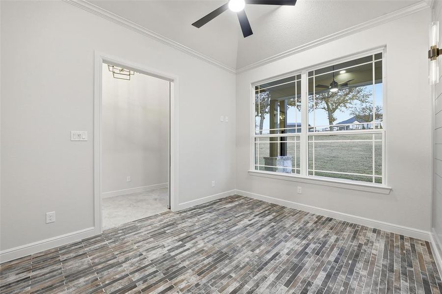 Empty room with ornamental molding and a ceiling fan Empty room with ornamental molding and a ceiling fan