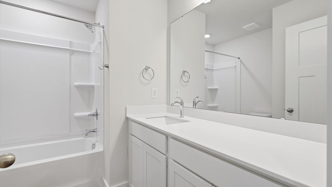 Accomplished bathroom design with sleek tile, high-quality cabinetry, and refined hardware
