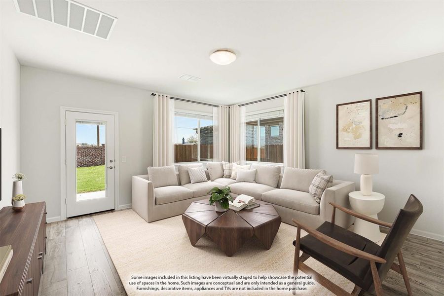 Bright living room with sectional sofa, wood coffee table, and back door leading to yard