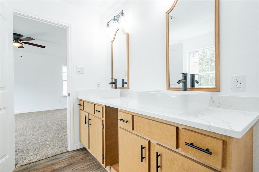 Bathroom featuring vanity, ceiling fan, and hardwood / wood-style floors