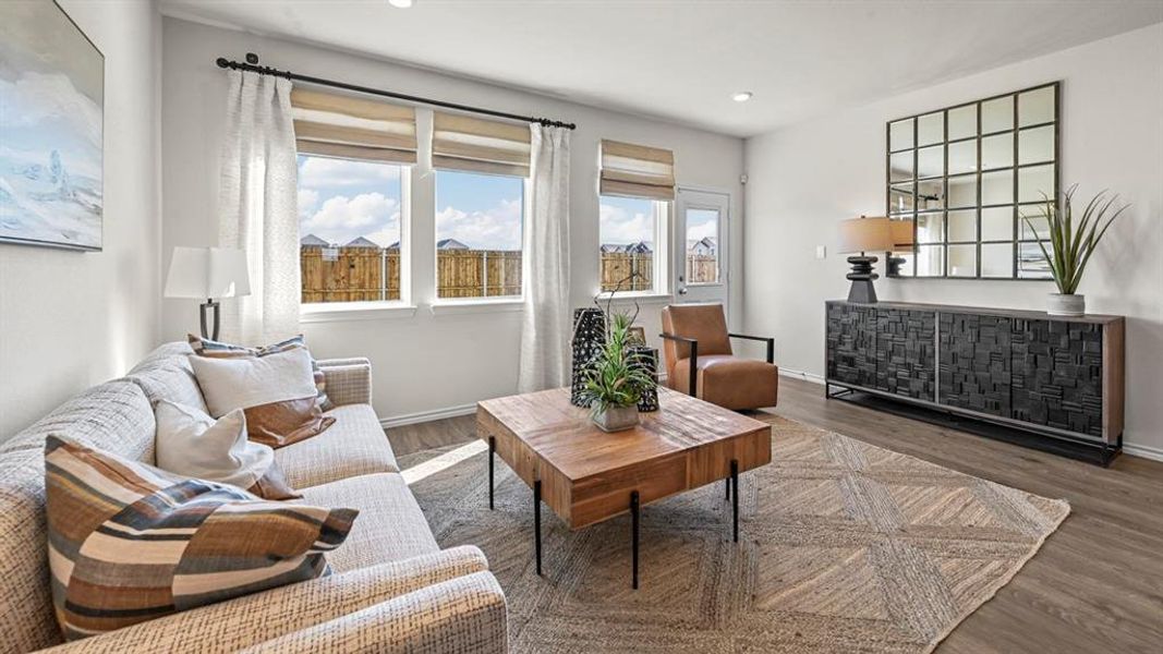 Living area with wood finished floors and recessed lighting
