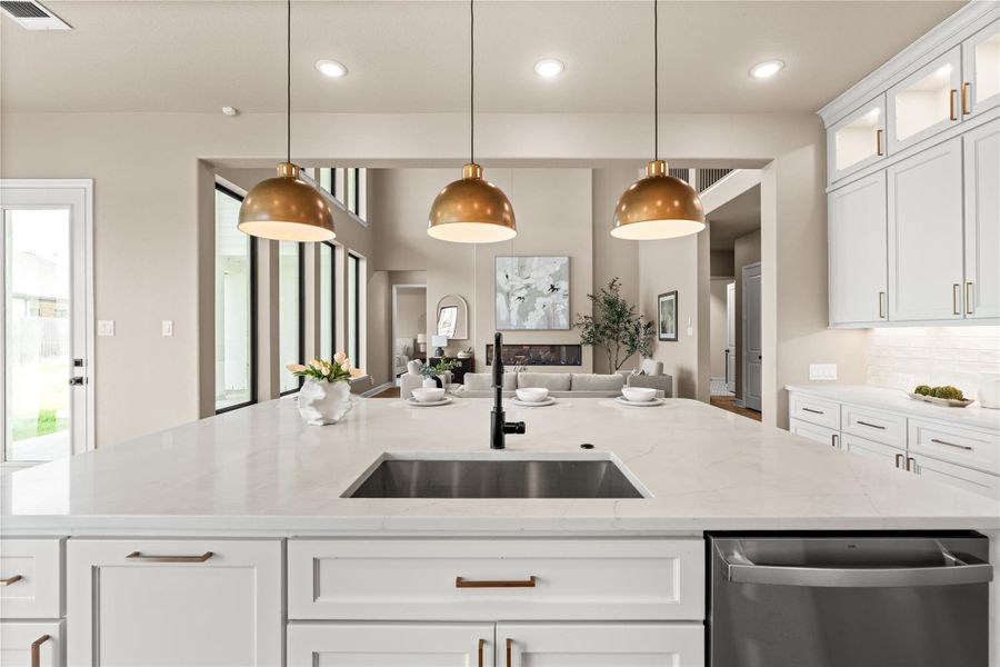 Gorgeous pendant lights and quartz countertops. You can't go wrong with this gourmet kitchen. *Virtually Staged*