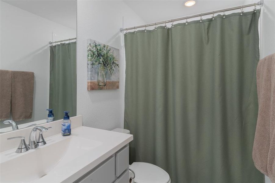 Full bathroom with vanity and toilet