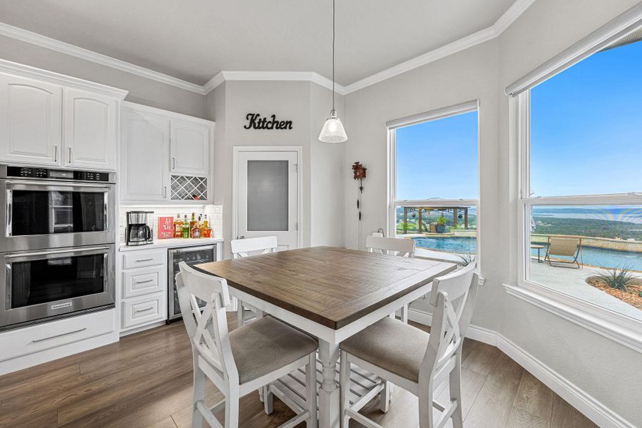 A well-lit kitchen boasts ample counter space, built-in appliances, and a dedicated wine rack, perfect for entertaining. A well-lit kitchen boasts ample counter space, built-in appliances, and a dedicated wine rack, perfect for entertaining.