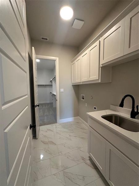 Primary closet conveniently connects to the utility room