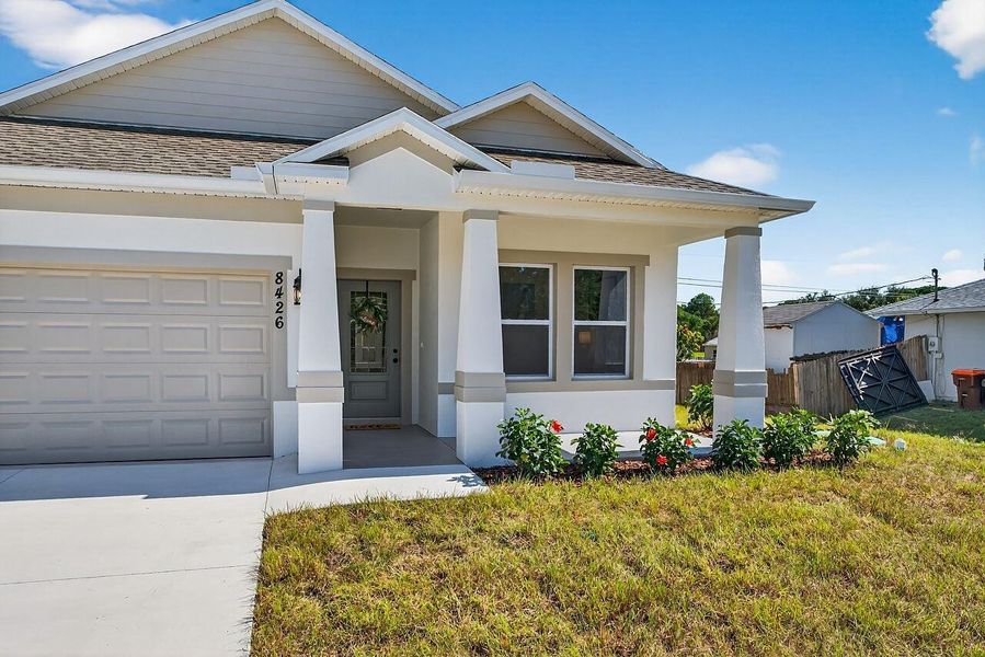 Front exterior of a new home in , Vero Beach, FL, highlighting curb appeal (Image 1).