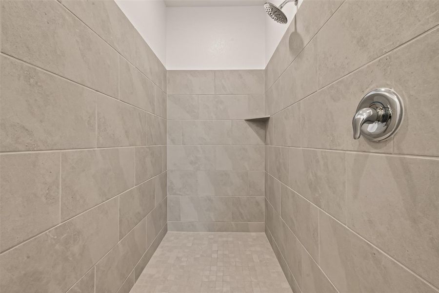 Spacious walk-in shower with modern tile finishes and a clean, contemporary feel.