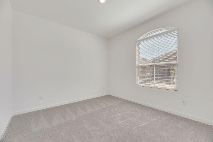 Empty room with light carpet and baseboards Empty room with light carpet and baseboards