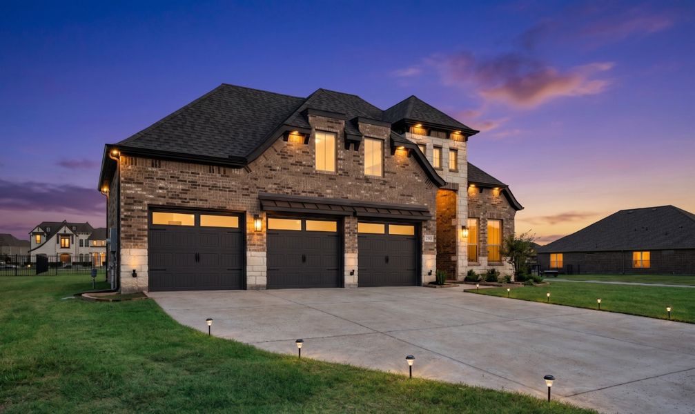 Front exterior of a new home in Heath Golf and Yacht Club, Heath, TX, highlighting curb appeal (Image 2). Front exterior of a new home in Heath Golf and Yacht Club, Heath, TX, highlighting curb appeal (Image 2).