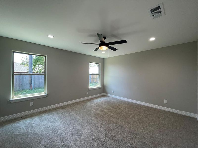 Spare room featuring ceiling fan and carpet