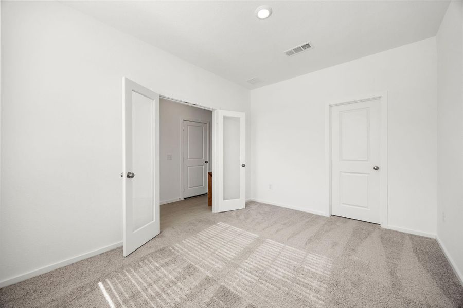 The downstairs secondary bedroom offers flexibility for guests, a home office, nursery, or multigenerational living, all conveniently located near the main living areas.