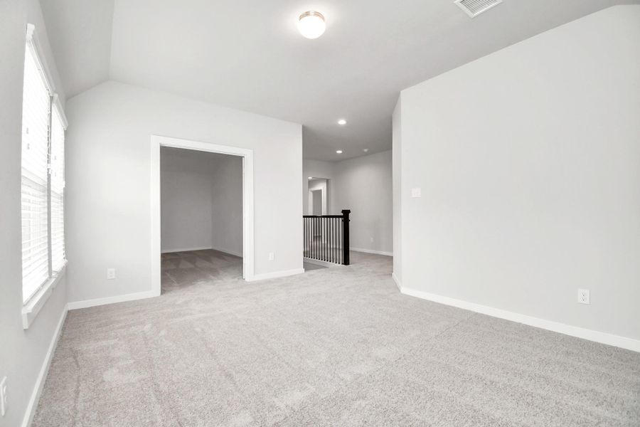 Come upstairs and enjoy a day of leisure in this fabulous game room! This is the perfect hangout spot or adult game room! Features plush carpet, high ceilings, custom paint and windows for plenty of natural light. Sample photo of completed home with similar floor plan. As-built interior colors and selections may vary. Come upstairs and enjoy a day of leisure in this fabulous game room! This is the perfect hangout spot or adult game room! Features plush carpet, high ceilings, custom paint and windows for plenty of natural light. Sample photo of completed home with similar floor plan. As-built interior colors and selections may vary.