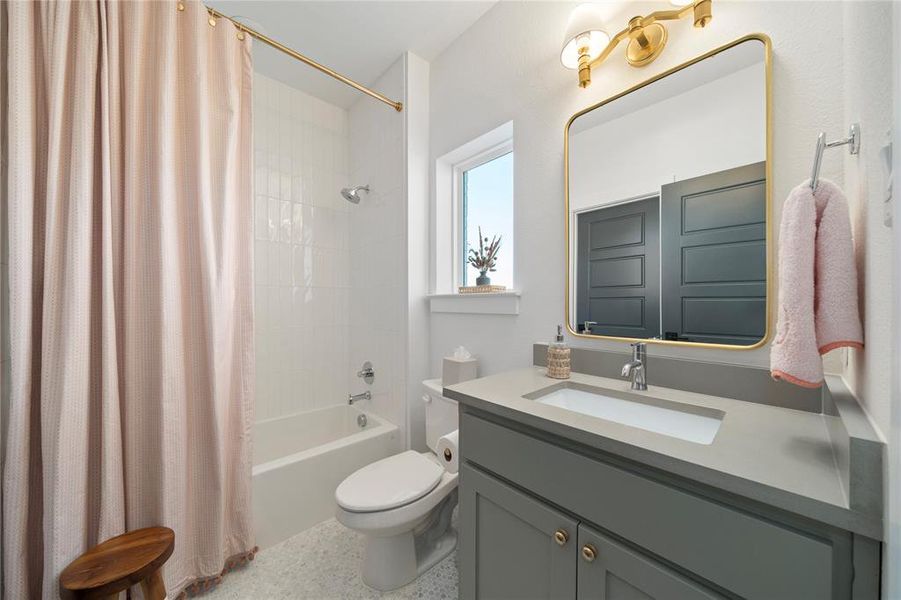 Full bathroom featuring shower / bath combination with curtain, vanity, and toilet