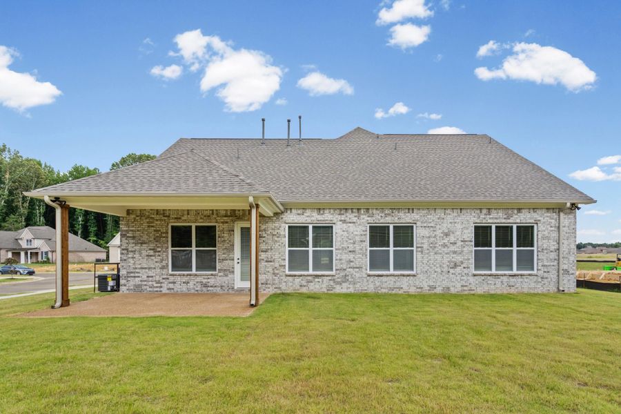 Rear exterior with light gray brick siding and a covered patio Rear exterior with light gray brick siding and a covered patio