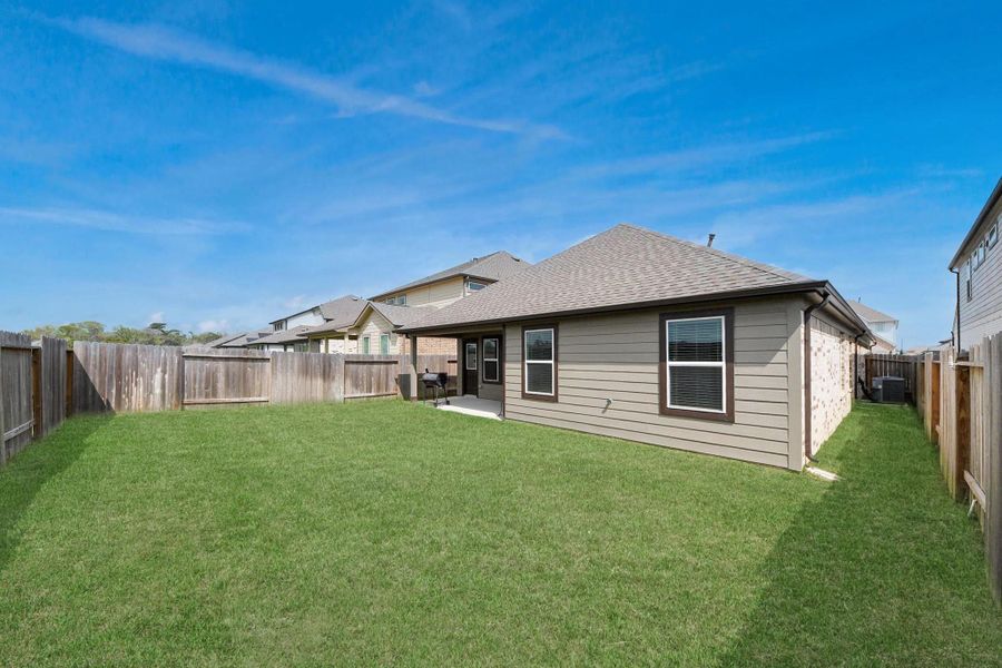 Well-maintenance lawn with full privacy fencing.