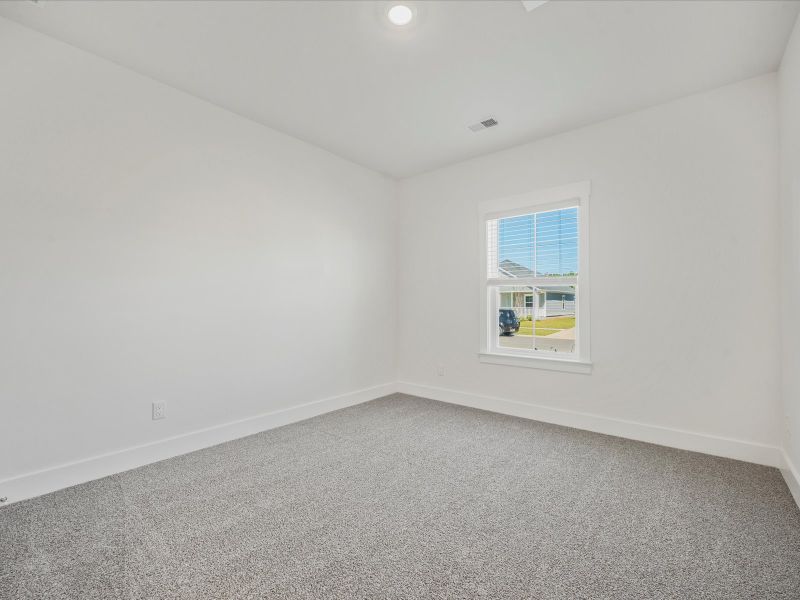 Spacious, unfurnished interior of a new home in The Coves at Lakes of Cane Bay II, Summerville (Image 26).
