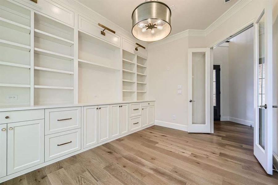 Unfurnished dining area with light hardwood / wood-style floors and crown molding