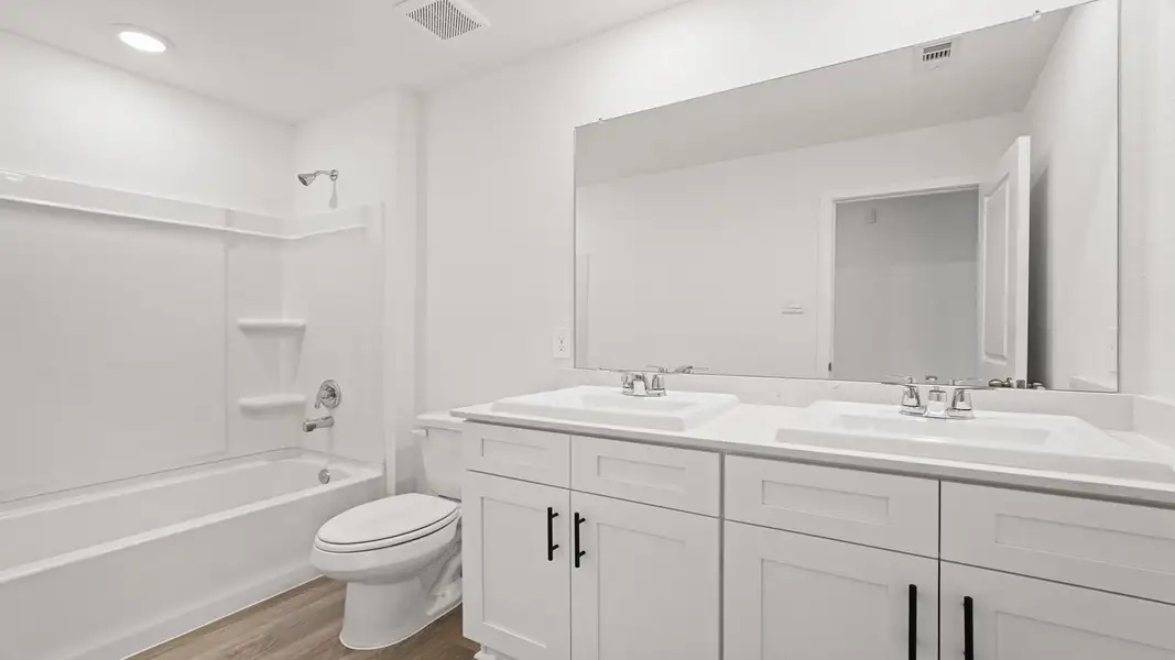 Furnished interior view inside a new home in Sunterra, Katy (Image 9).