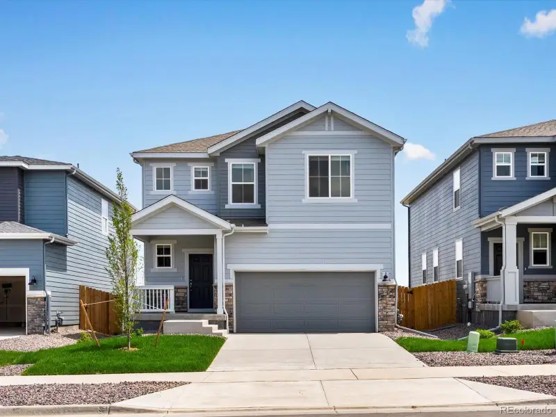 Front exterior of a new home in Lake Bluff, Greeley, CO, highlighting curb appeal (Image 1).