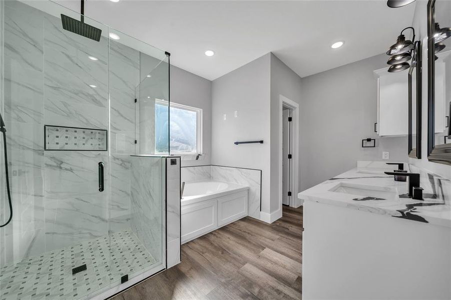 Bathroom featuring independent shower and bath, wood-type flooring, and vanity