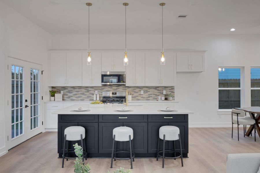 Open-concept design featuring a stylish kitchen with quartz countertops and a spacious dining area. Open-concept design featuring a stylish kitchen with quartz countertops and a spacious dining area.
