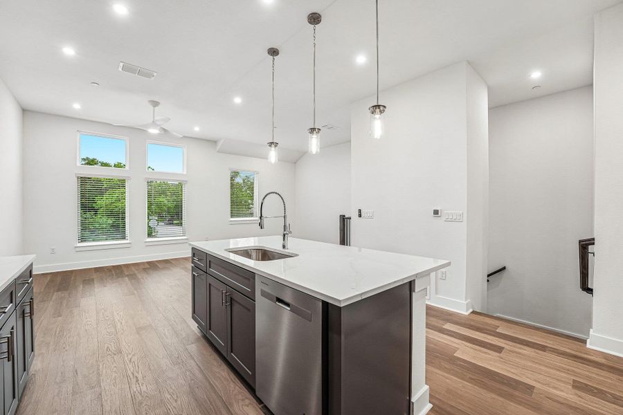 The kitchen is the heart of theliving space, featuring a largequartz island and stylish pendantlights hanging above. The kitchen is the heart of theliving space, featuring a largequartz island and stylish pendantlights hanging above.