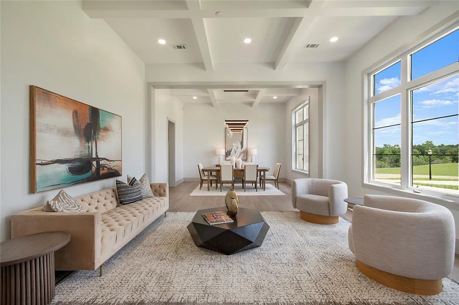 Living room with coffered ceiling, wood finished floors, recessed lighting, and beamed ceiling