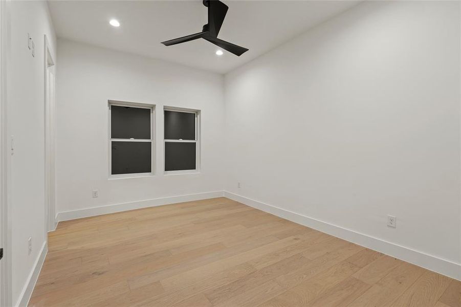 Empty room with light wood-type flooring, recessed lighting, and ceiling fan