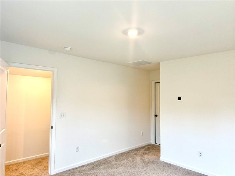 Soft carpeting pairs with neutral walls in this ve