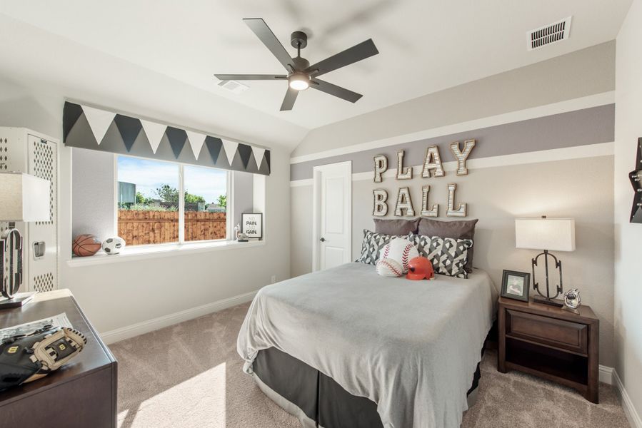 Kids' bedroom with sports theme, gray striped walls, ceiling fan, and "Play Ball" wall letters
