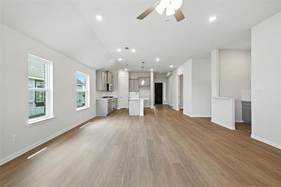 Unfurnished living room with ceiling fan, light wood-type flooring, and recessed lighting
